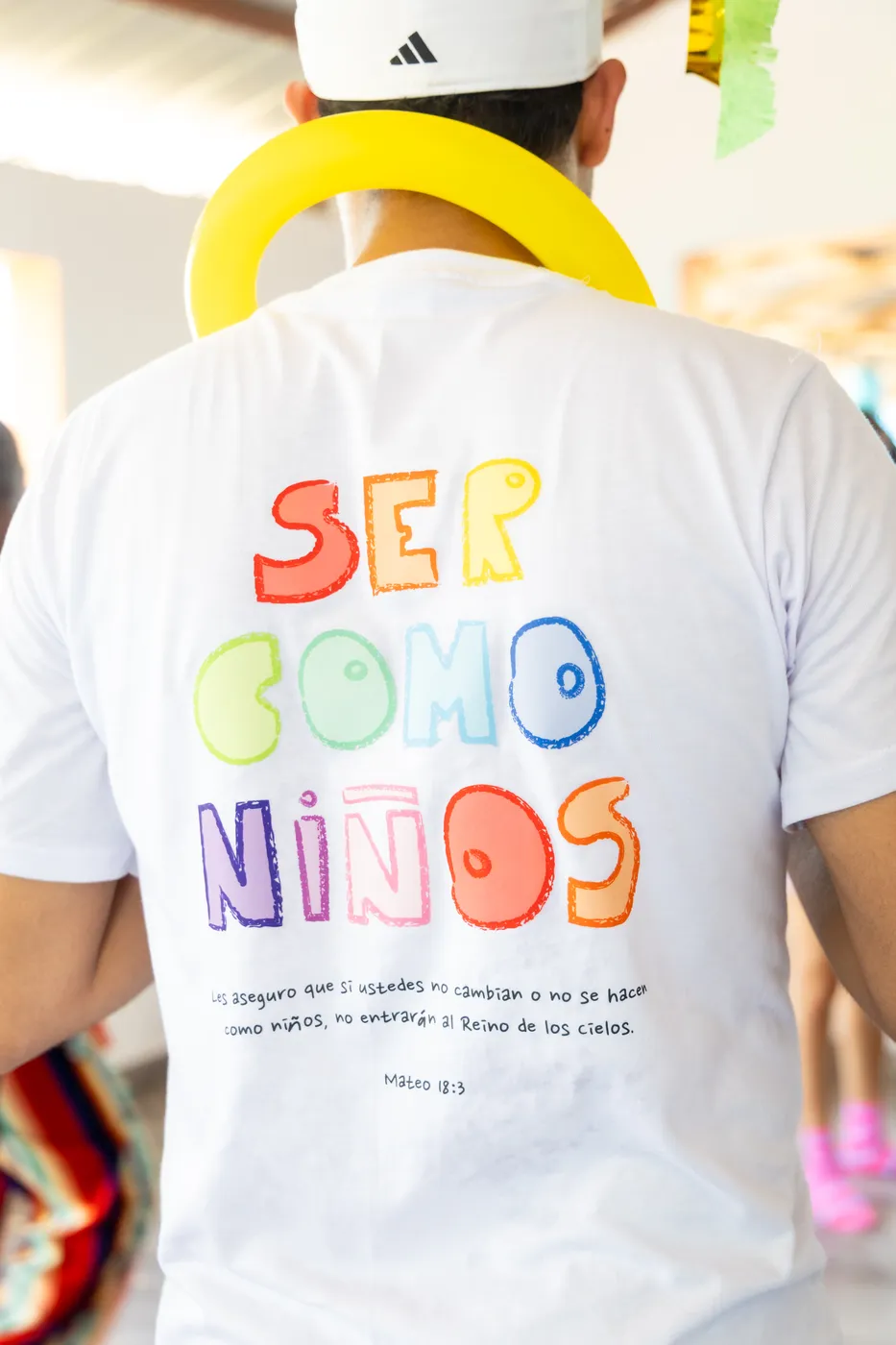 Detalle del estampado “Ser como niños” en la camiseta del voluntariado